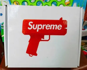 Đồ chơi giải trí súng bắn tiền Supreme The Cash Cannon gun chạy bằng pin