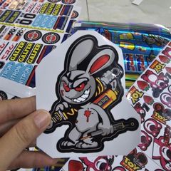 Tem Sticker Thỏ Điên Cầm Phuộc 10cm - Tem Dán 3 Lớp Cao Cấp, Chống Nước, Bảo Hành Trọn Đời, Trang Trí Ô Tô, Xe Máy, Xe Đạp