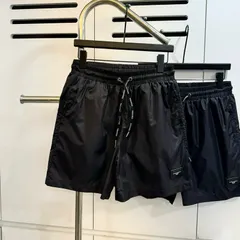 Quần đùi nam nữ thiết kế đen trơn gắn tag da  quần short gió 2 lớp hot 2026