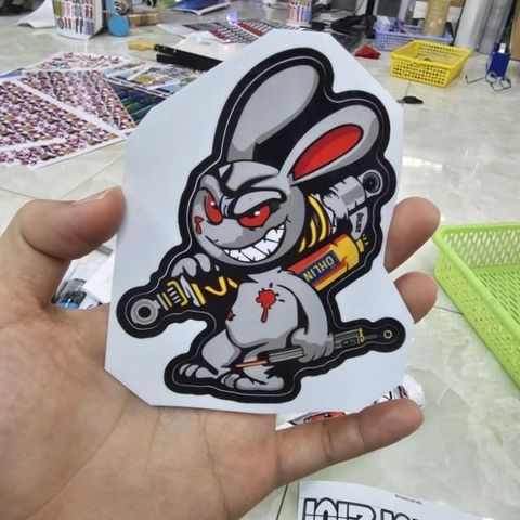 Tem Sticker Thỏ Điên Cầm Phuộc 10cm - Tem Dán 3 Lớp Cao Cấp, Chống Nước, Bảo Hành Trọn Đời, Trang Trí Ô Tô, Xe Máy, Xe Đạp