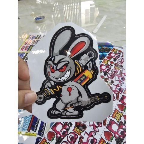 Tem Sticker Thỏ Điên Cầm Phuộc 10cm - Tem Dán 3 Lớp Cao Cấp, Chống Nước, Bảo Hành Trọn Đời, Trang Trí Ô Tô, Xe Máy, Xe Đạp