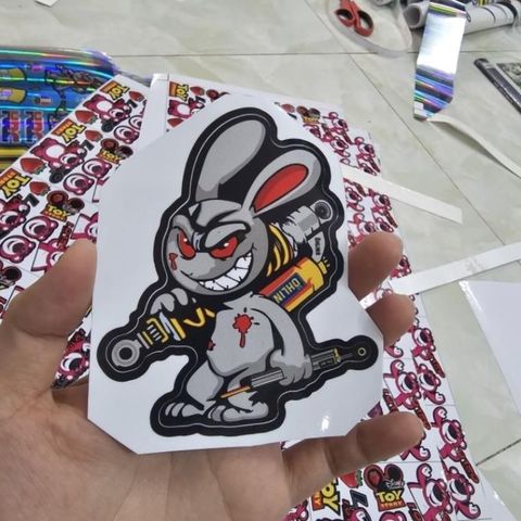 Tem sticker thỏ điên cầm phuộc OH 10cm trang trí xe máy, điện thoại, laptop