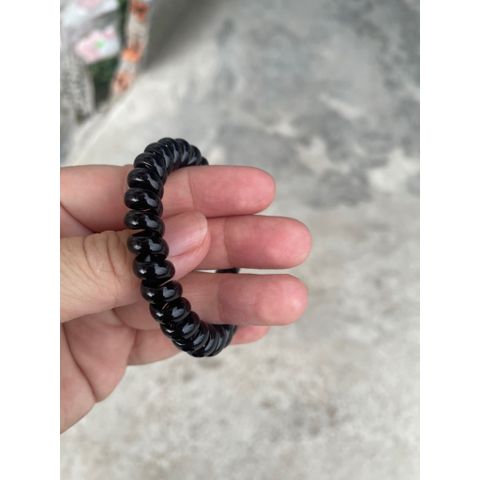 Gói 100 chun buộc tóc nhựa xoắn màu đen