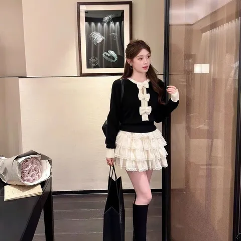 Áo len dài tay đính nơ đen trắng xinh xắn tiểu thư