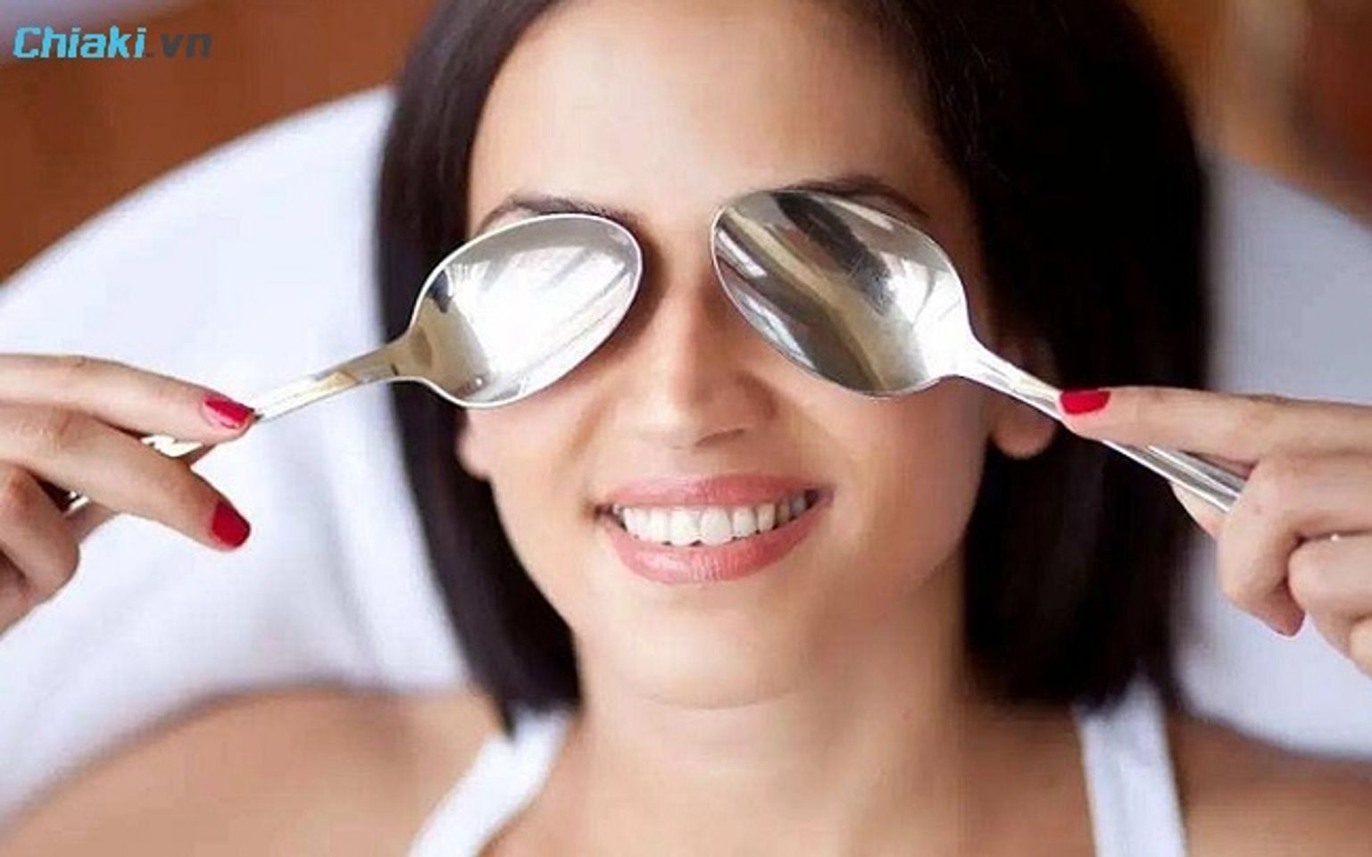 Bạn c&oacute; thể sử dụng 2 th&igrave;a nh&uacute;ng nước lạnh để massage mắt khỏi sưng sau kh&oacute;c